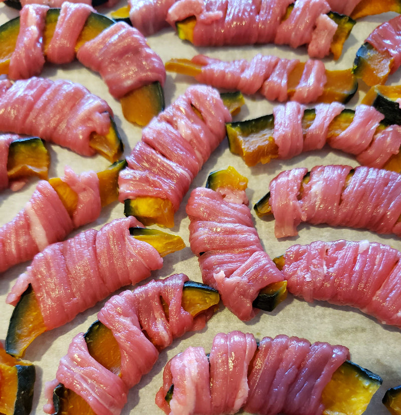 Dog eagerly taking a handmade natural dog treat from owner